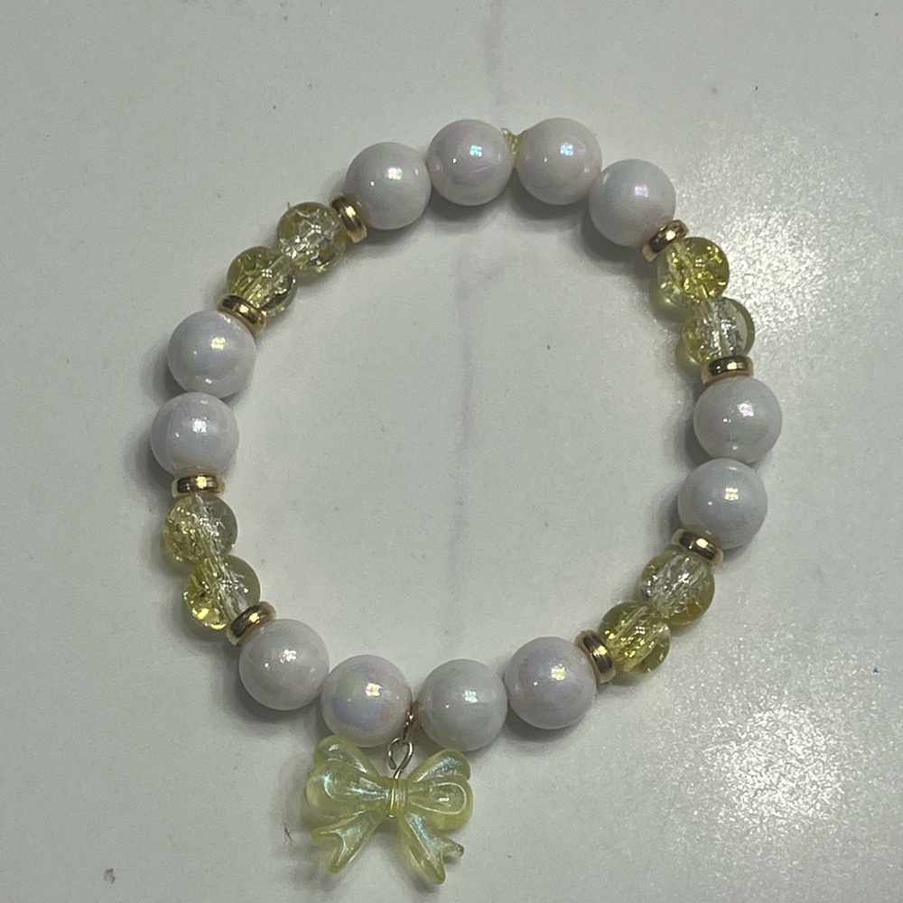 White and Yellow Beaded Bracelet with Bow Charm